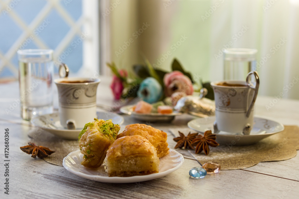 Two cups of Turkish coffee and plate with baklava