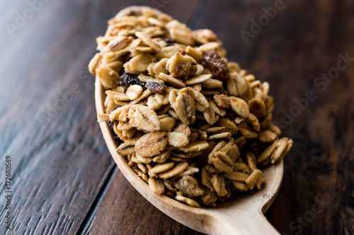 Granola and ingredients in wooden spoon