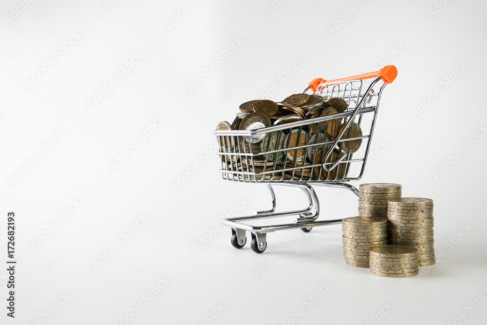 Stack of coins and coins in shopping trolley cart