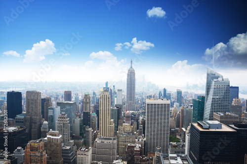 Manhattan panorama in summer time with blue sky  Empire State Building in the center of the picture