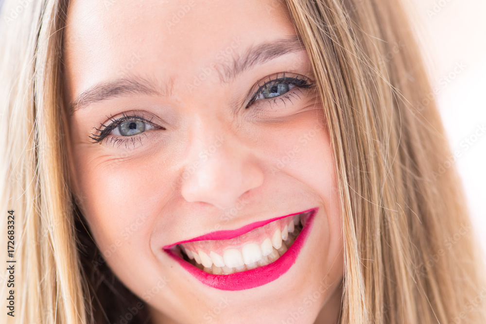 Happy young girl outdoors, front portrait photo with defocused copy space background Happy young girl outdoors, front portrait photo with defocused copy space background