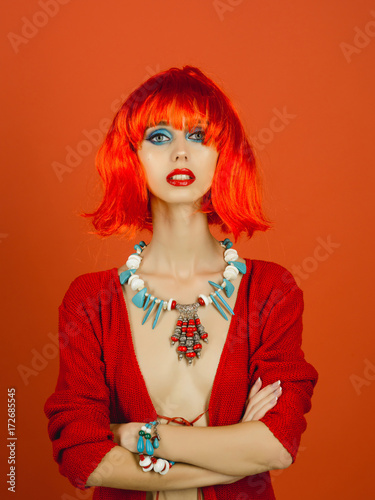 Girl with bright artificial hair in ethnic jewelry.