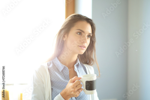 happy woman drinking tea in the kitchen at home. Woman at home