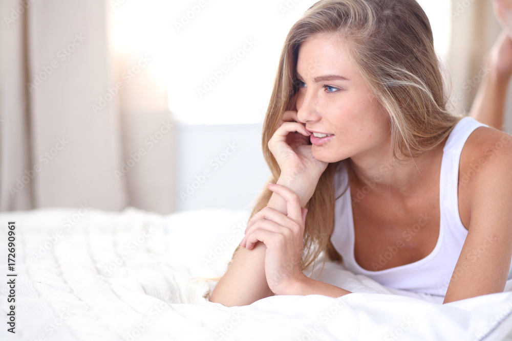 Pretty woman lying down on her bed at home . Pretty woman Pretty woman lying down on her bed at home . Pretty woman