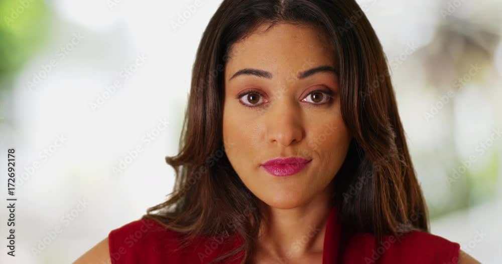 Close up of attractive Latina female staring at camera with calm expression on unfocused background. Portrait of beautiful young woman looking at camera with confidence. 4k Close up of attractive Latina female staring at camera with calm expression on unfocused background. Portrait of beautiful young woman looking at camera with confidence. 4k