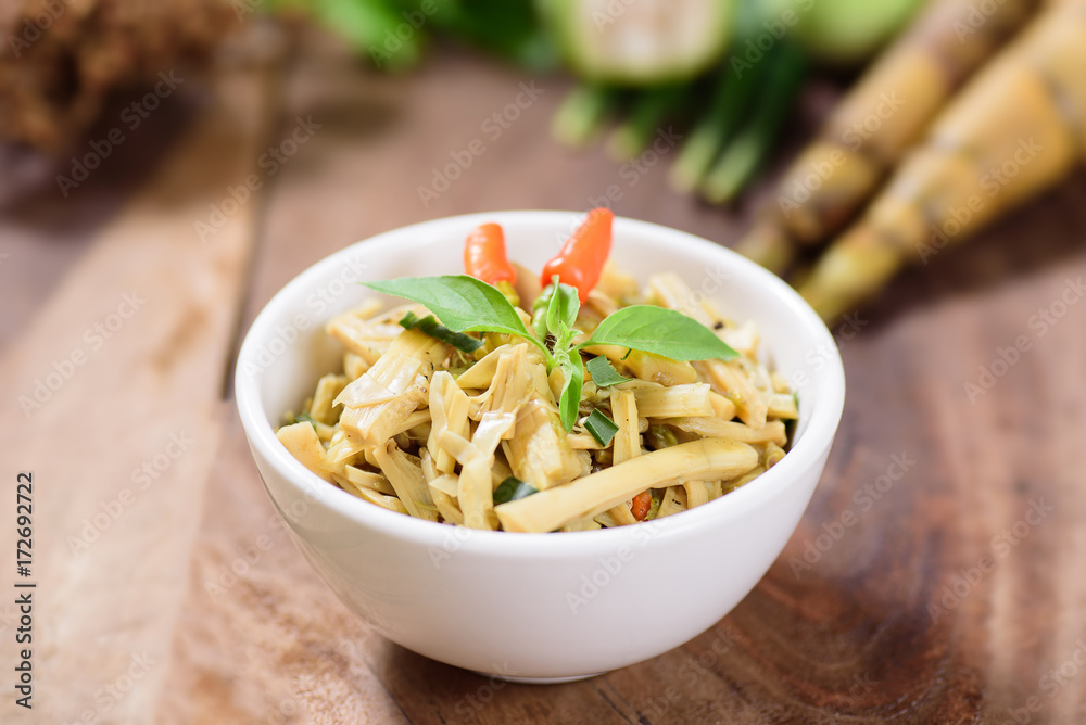 Thai Northern food (Yum Nor Mai),spicy bamboo shoot salad with crab paste  on wooden background