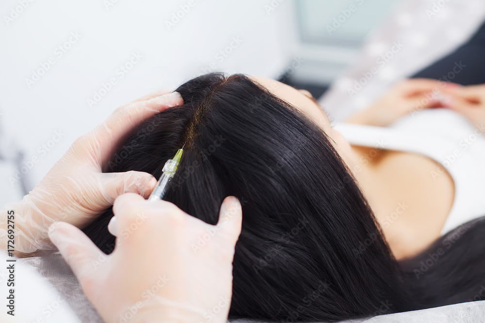 Naklejka premium Closeup of Beautiful young woman gets injection in eye and lips area from beautician. preservation of beauty concept