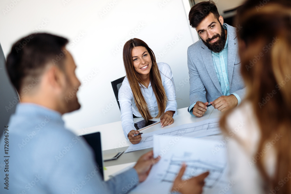 Portrait of young architects discussing in office Portrait of young architects discussing in office