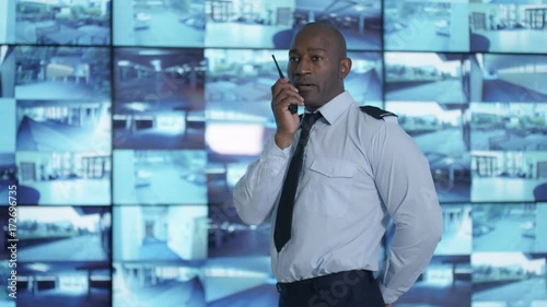 Wallpaper Mural  Security officer watching CCTV video screens & talking on radio Torontodigital.ca
