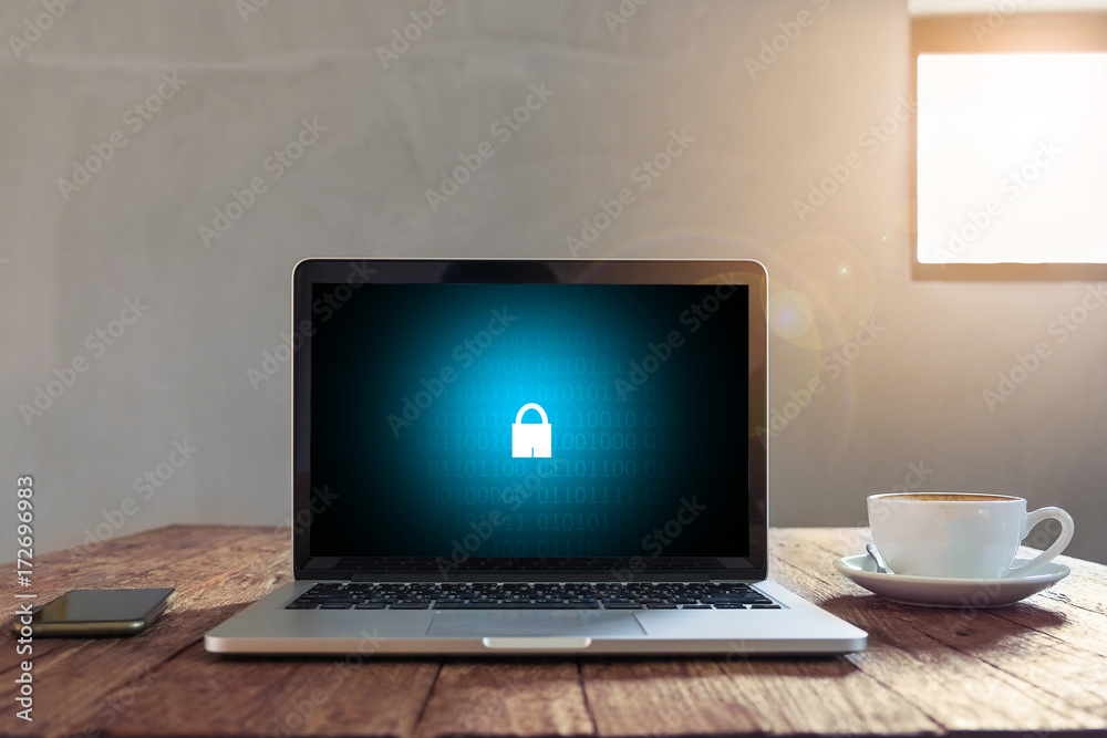 Laptop on wooden desk with security concept on screen, Business, technology, internet and networking concept. Laptop on wooden desk with security concept on screen, Business, technology, internet and networking concept.