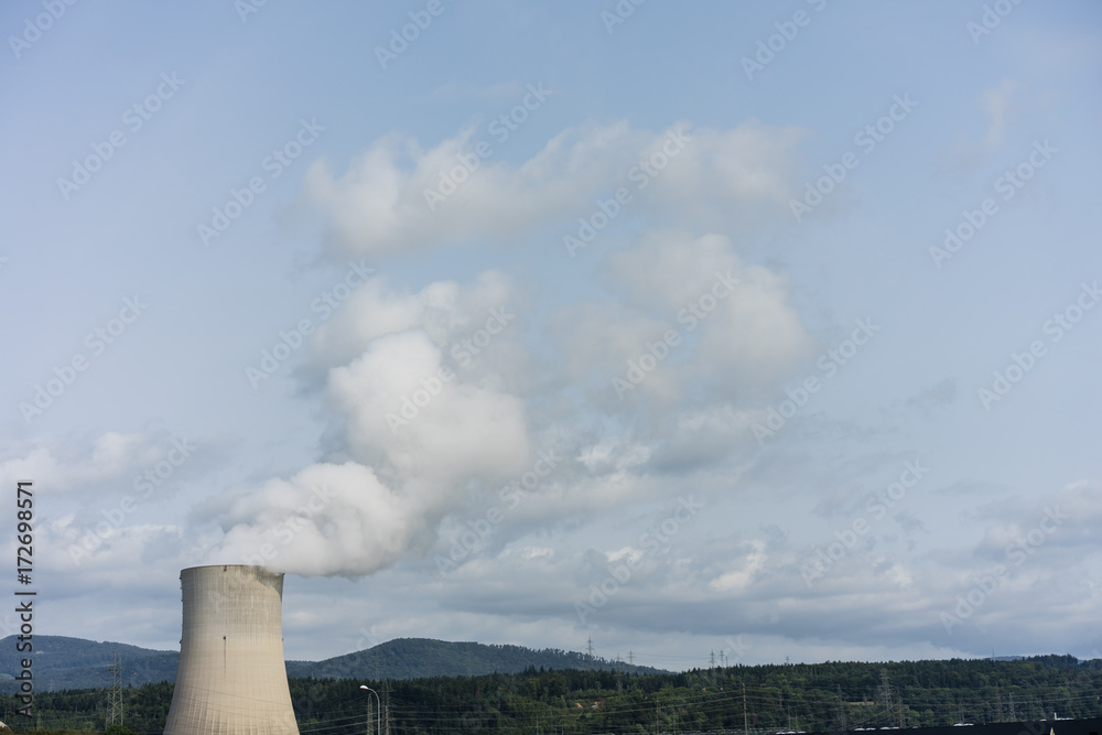 nuclear power plant chimney with landscape mountain meadow green fielw and sky nuclear power plant chimney with landscape mountain meadow green fielw and sky
