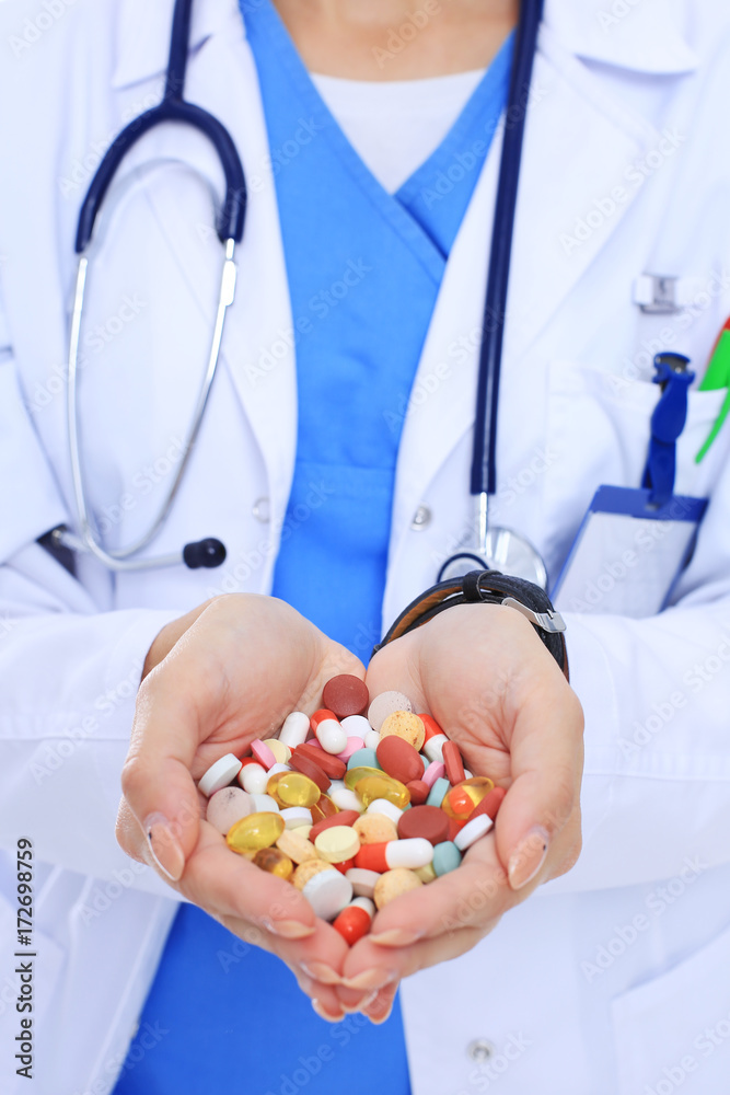 Doctor holding heap of drugs in a hand. Woman doctor Doctor holding heap of drugs in a hand. Woman doctor