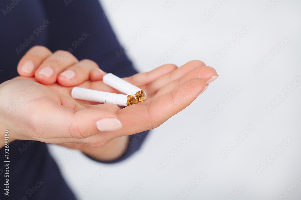 Stop Smoking. Beautiful Woman Breaking Cigarette In Half Stop Smoking. Beautiful Woman Breaking Cigarette In Half