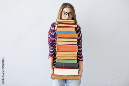 Student woman holding pile books