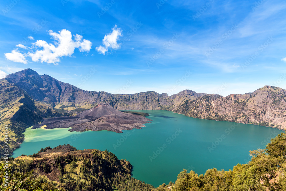 landscape of active volcano Baru Jari, Lake Segara Anak and summit of Rinjani mountain. Lombok island, Indonesia.