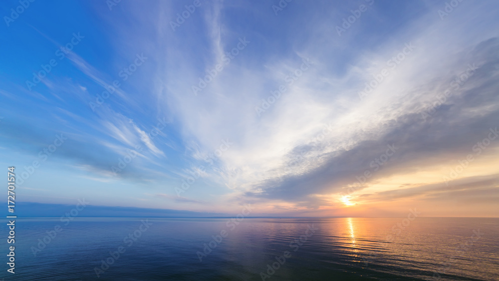 Fototapeta premium sunrise on the water / Early summer morning bright sky Beach