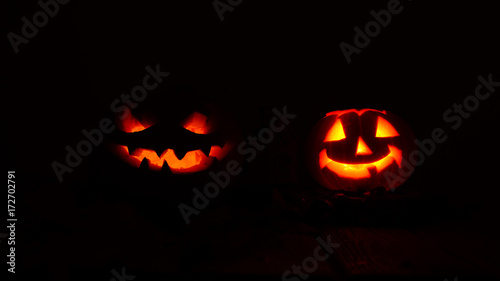 Creepy halloween pumpkins in the dark. Silhouette of pumpkin. Candle inside.