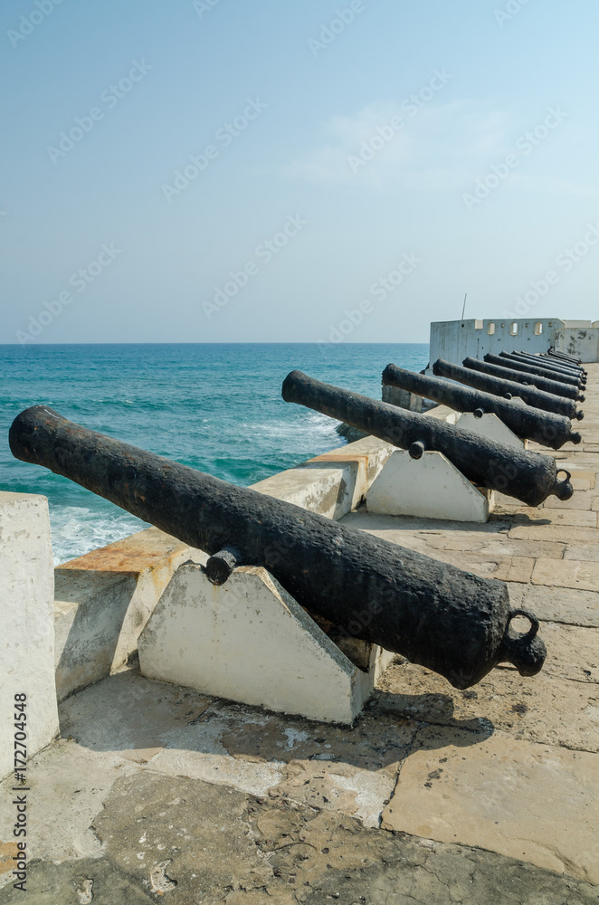Famous slave trading fort of colonial times Cape Coast Castle with old cannons and white washed walls, Ghana, Africa Famous slave trading fort of colonial times Cape Coast Castle with old cannons and white washed walls, Ghana, Africa