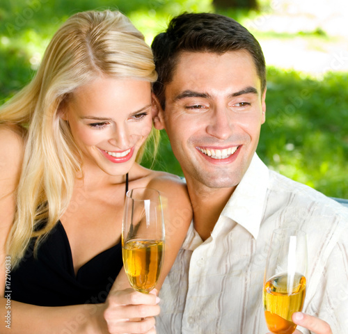 Young happy couple with champagne, outdoor