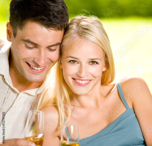 Young happy couple with champagne, outdoor