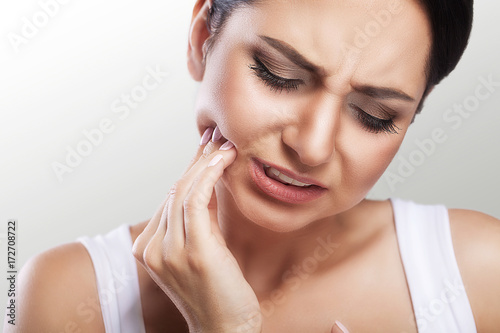 Teeth Problem. Woman Feeling Tooth Pain. Closeup Of A Beautiful Sad Girl Suffering From Strong Tooth Pain. Attractive Female Feeling Painful Toothache. Dental Health And Care Concept.