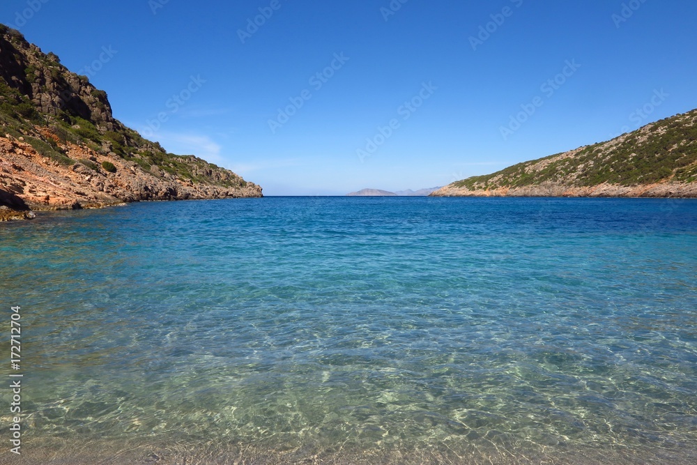Fototapeta premium Tranquil blue sea cove with copy space. Symbol of solitude, escape, relaxation. 