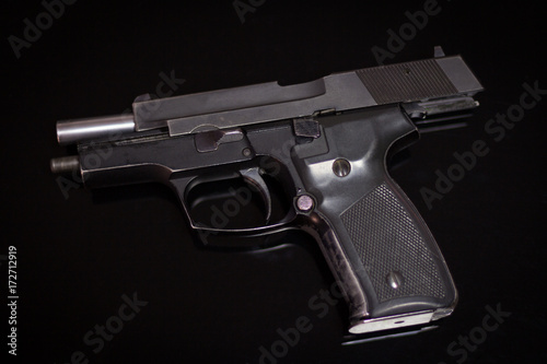 Handgun in the rear position isolated on black