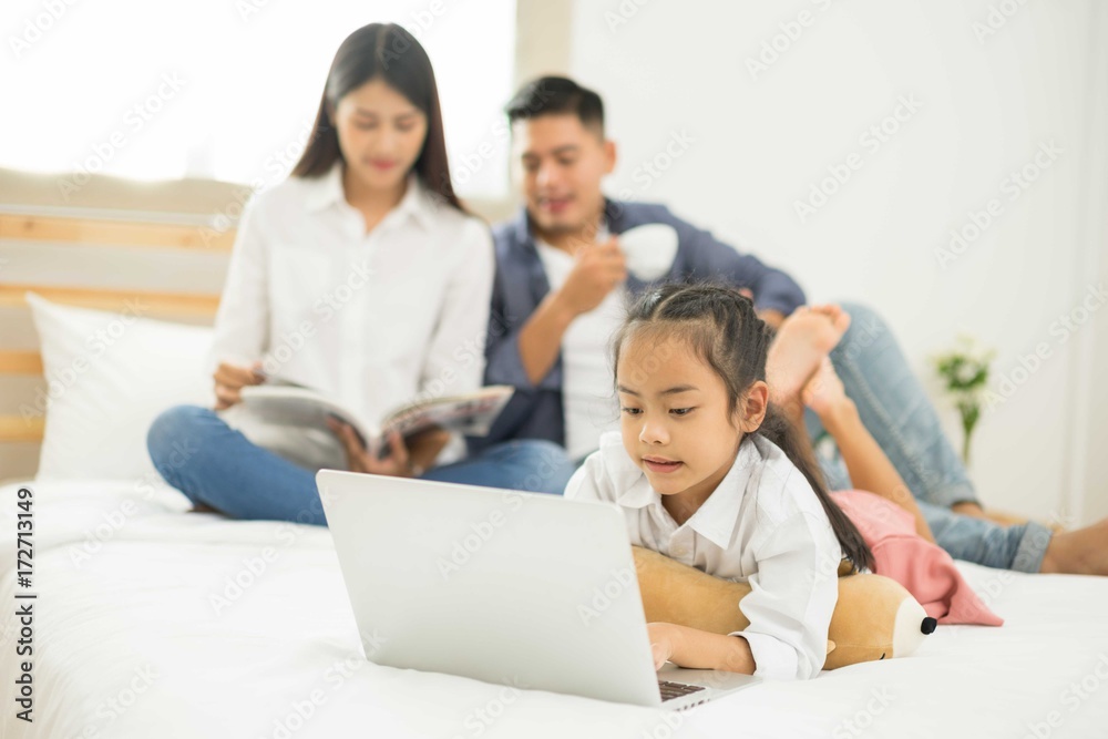 Asia kids happy loving family. pretty young mother reading a notebook to her daughters Asia kids happy loving family. pretty young mother reading a notebook to her daughters
