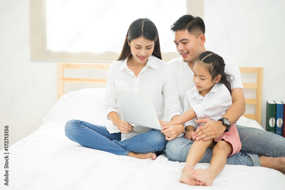 Asia kids happy loving family. pretty young mother reading a notebook to her daughters Asia kids happy loving family. pretty young mother reading a notebook to her daughters