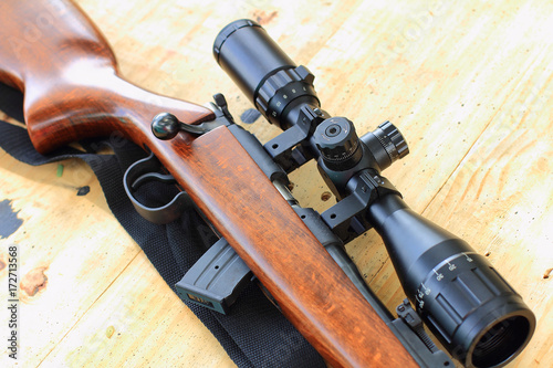 close up of rifle telescope for sport hunting on table wooden