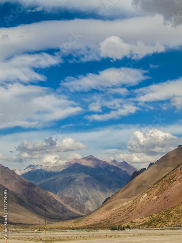 Andes mountains landscape with beautiful blue sky and scenic clouds