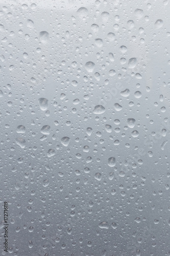 Light rain on the window glass, grainy texture on background