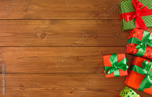 Colorful present boxes for any holiday on wooden background