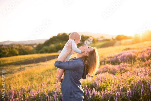 Young mother in nature with baby son in the arms. #172718111