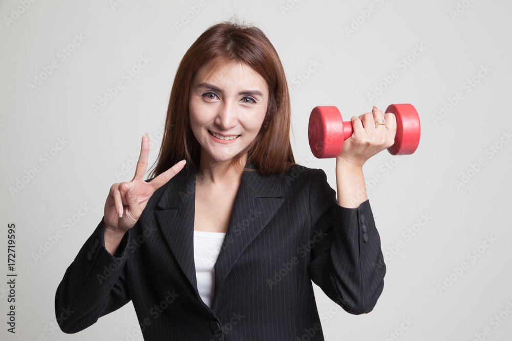 Healthy Asian business woman show victory sign with dumbbells.