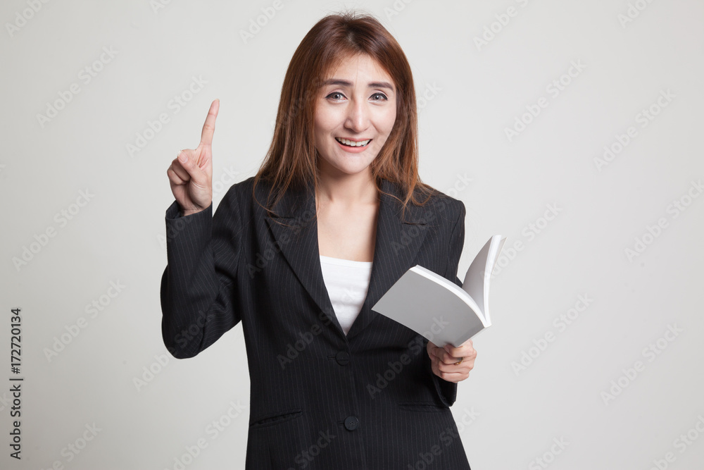 Young Asian woman with a book have an idea. Young Asian woman with a book have an idea.