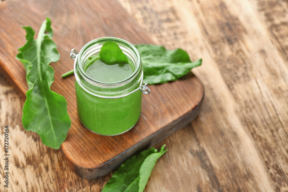 Jar of spinach smoothie on table Jar of spinach smoothie on table