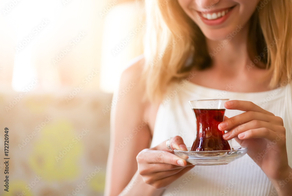 Woman drinking delicious traditional Turkish tea in cafe Woman drinking delicious traditional Turkish tea in cafe