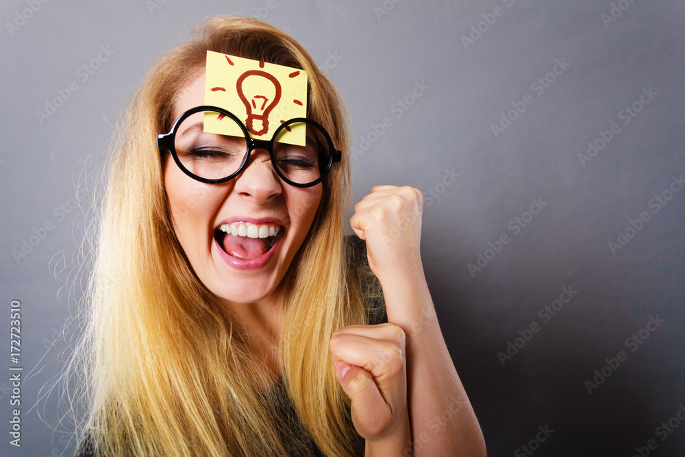 Fotografie Woman having light bulb mark on forehead thinking