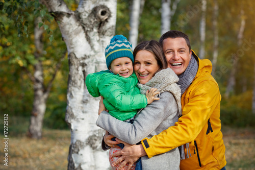 Happy family playing in autumn park