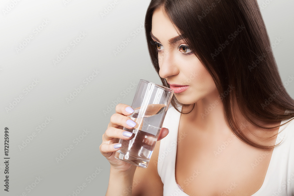 Healthy Lifestyle. Portrait of a happy smiling young woman with a glass of fresh water. Health Drinks Health, Beauty, Concept Diet. Healthy Eating. Healthy Lifestyle. Portrait of a happy smiling young woman with a glass of fresh water. Health Drinks Health, Beauty, Concept Diet. Healthy Eating.