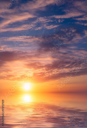 Romantic beautiful sunset in the sky and clouds over the sea. © Sviatoslav Khomiakov
