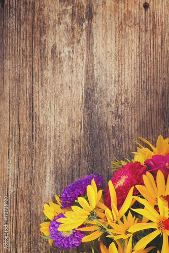 Bright fall bouquet on wooden background with copy space, retro toned