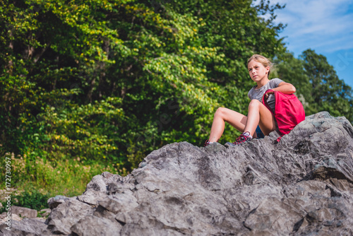 Girl resting on a rock