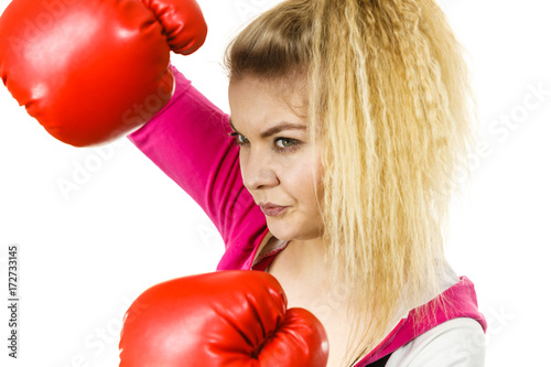 Woman wearing boxing gloves © Voyagerix