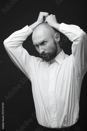 young white beard man white shirt black pants studio monochrome background