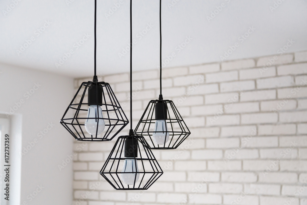 A modern loft chandelier made of black wire in a stylish white interior  Stock Photo | Adobe Stock
