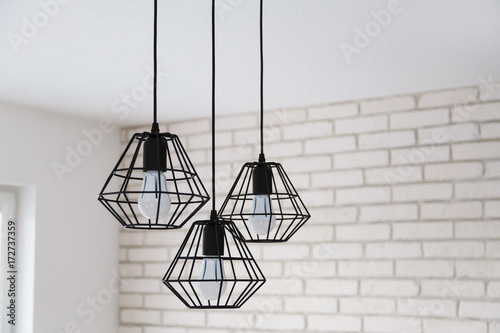 Obraz na płótnie A modern loft chandelier made of black wire in a stylish white interior w salonie