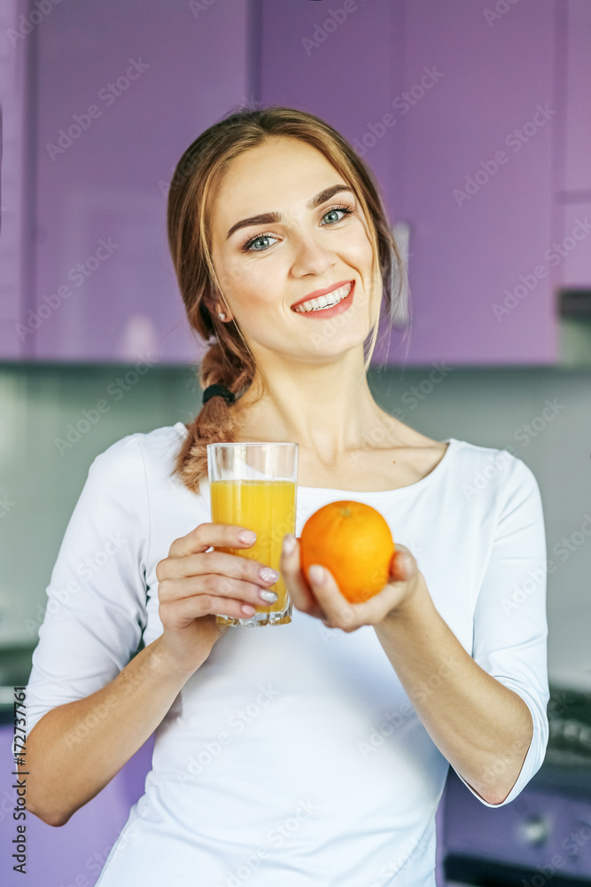 Young woman with orange juice. The concept is healthy food, diet, vegetarianism, weight loss. Young woman with orange juice. The concept is healthy food, diet, vegetarianism, weight loss.