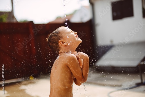 Boy is playing with the water photo